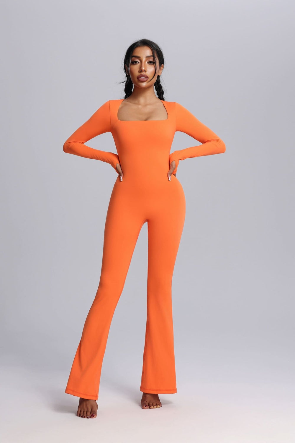Woman wearing a Orange UPF 50+ Yoga Jumpsuit with Thumbholes