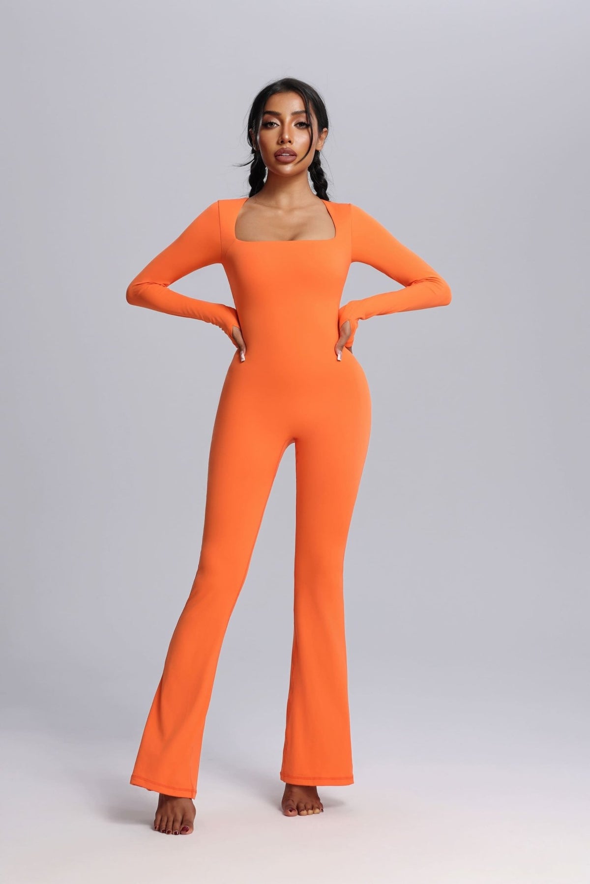 Woman wearing a Orange UPF 50+ Yoga Jumpsuit with Thumbholes
