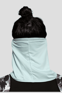 Person wearing a light blue neck gaiter against a plain background