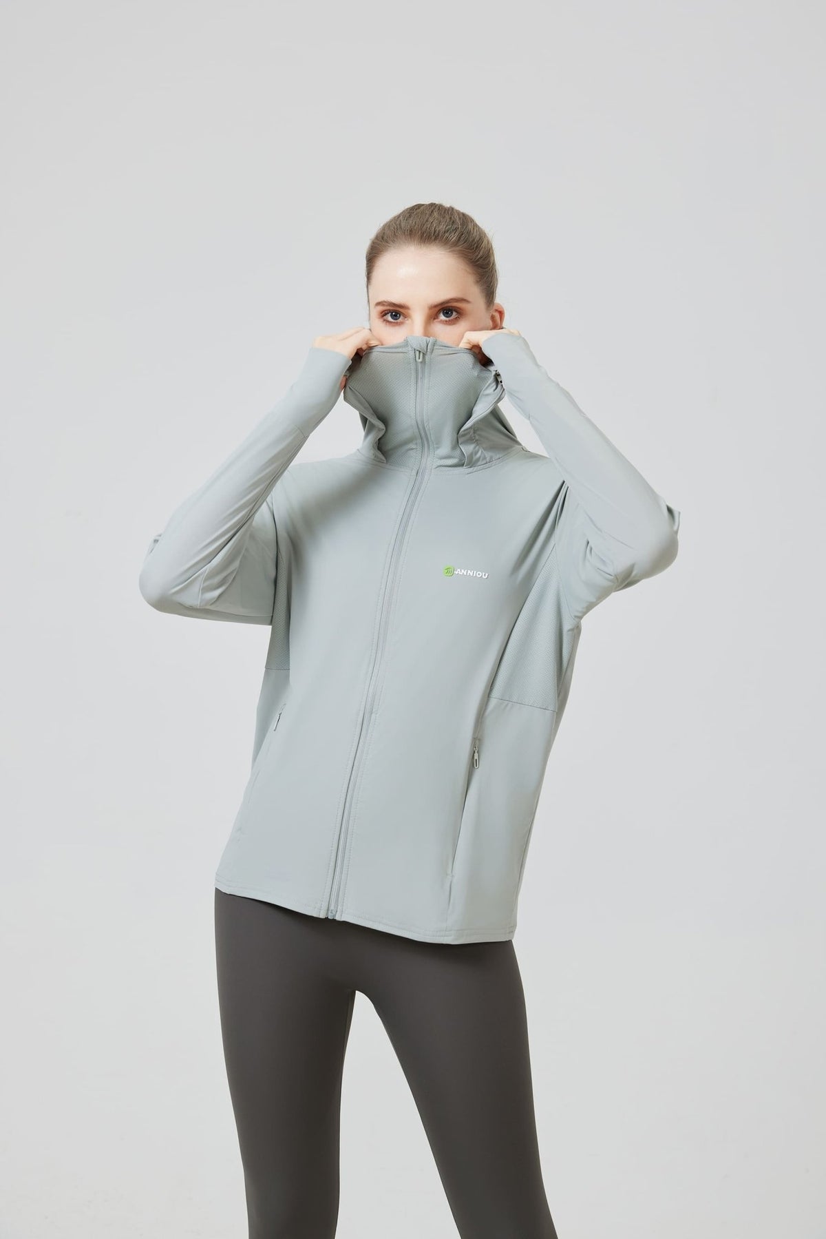 woman wearing a sports Jacket with zip and UPF 100 protective fabric protecting the face