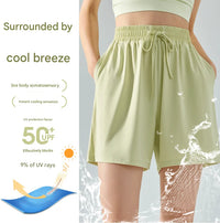 Light green shorts with UPF 50+ protection on a gray background