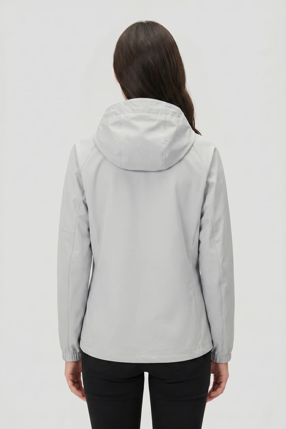 Person wearing a light gray hooded jacket on a white background