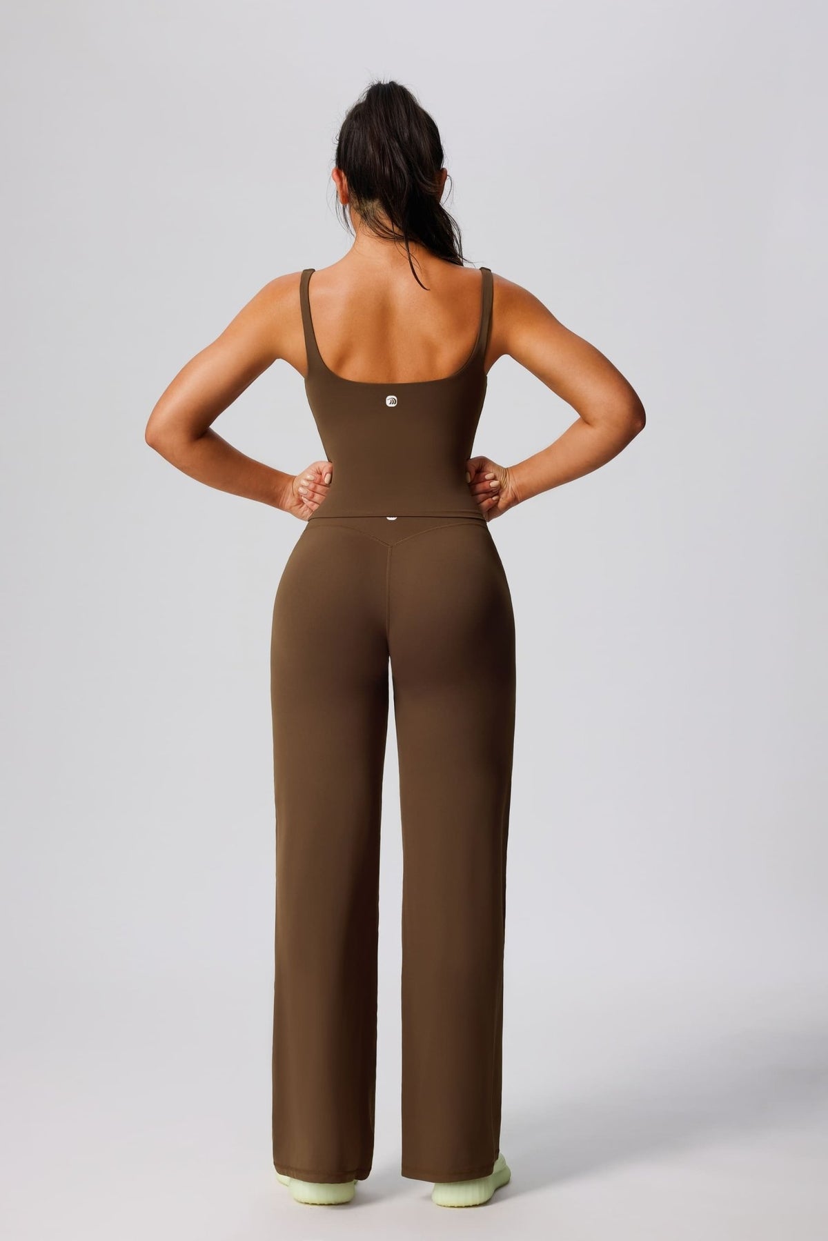 Women's UPF 50+ green yoga vest and pants from behind