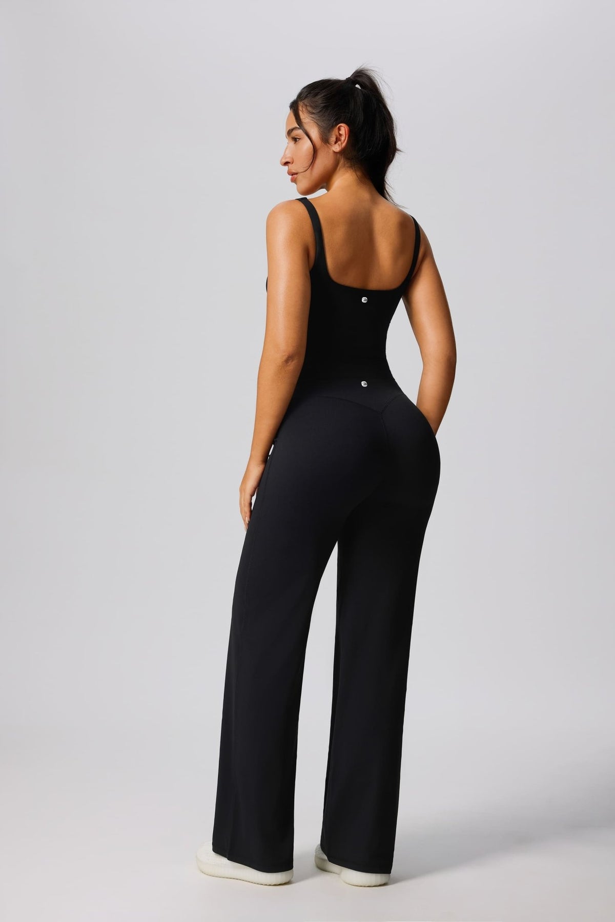 Women's UPF 50+ black yoga vest and pants behind