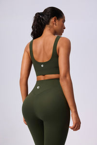 Person wearing an green sports bra and leggings set by Anniou