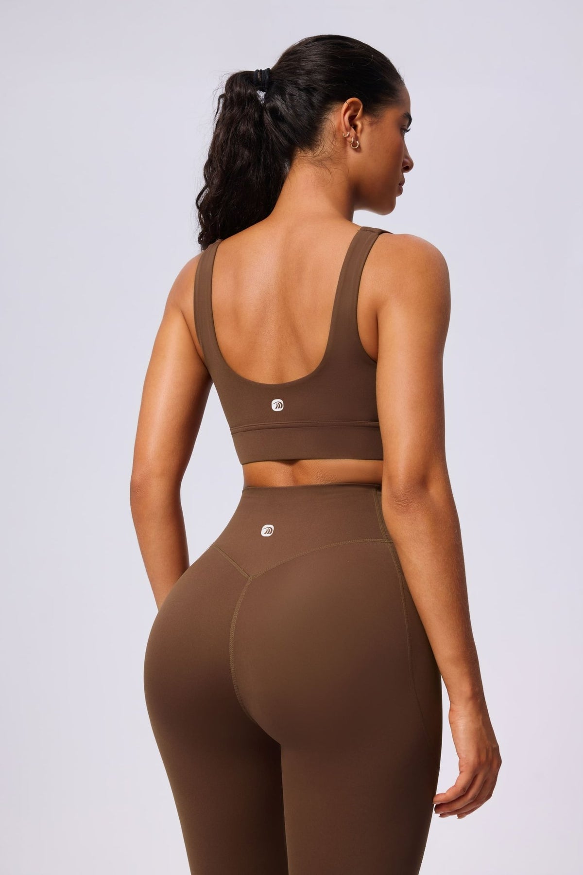 Woman wearing a brown yoga sports bra and leggings set