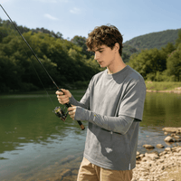 A young man wearing sun protection sleeves was fishing outdoors in gray