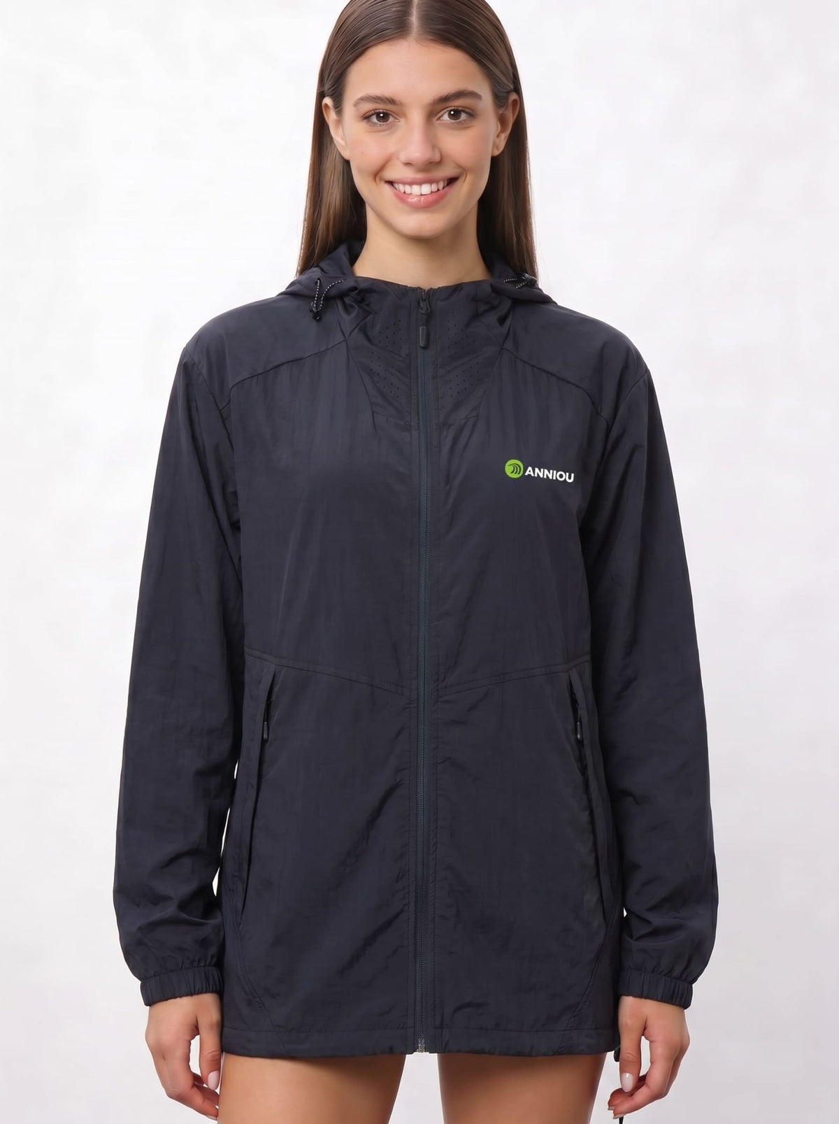 A woman wearing a navy UV protection hooded jacket with a full front zipper and a green and white Anniou logo on the left chest, and breathable vents