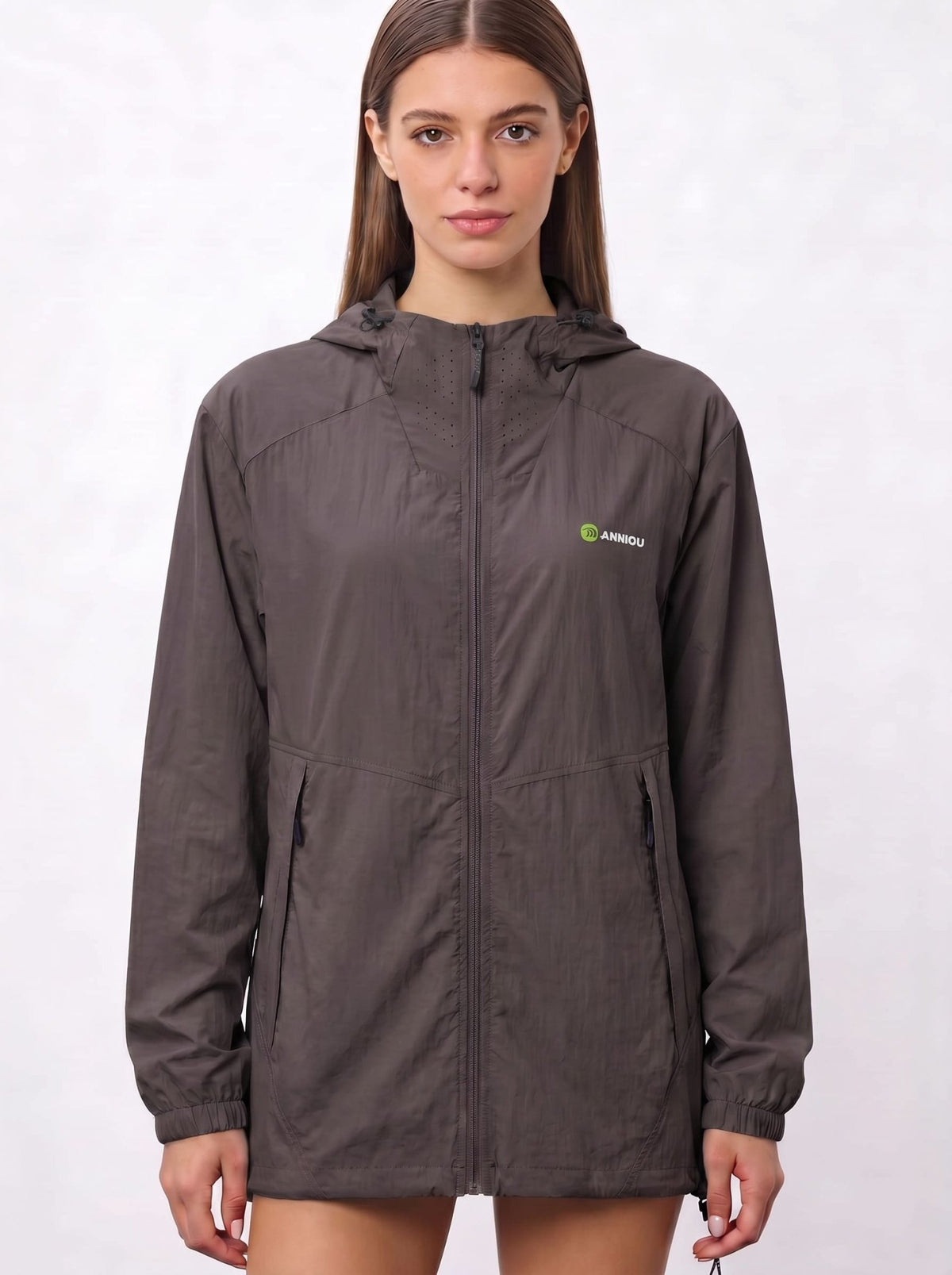 A woman wearing a dark brown UV protection hooded jacket with a full front zipper and a green and white Anniou logo on the left chest, and breathable vents