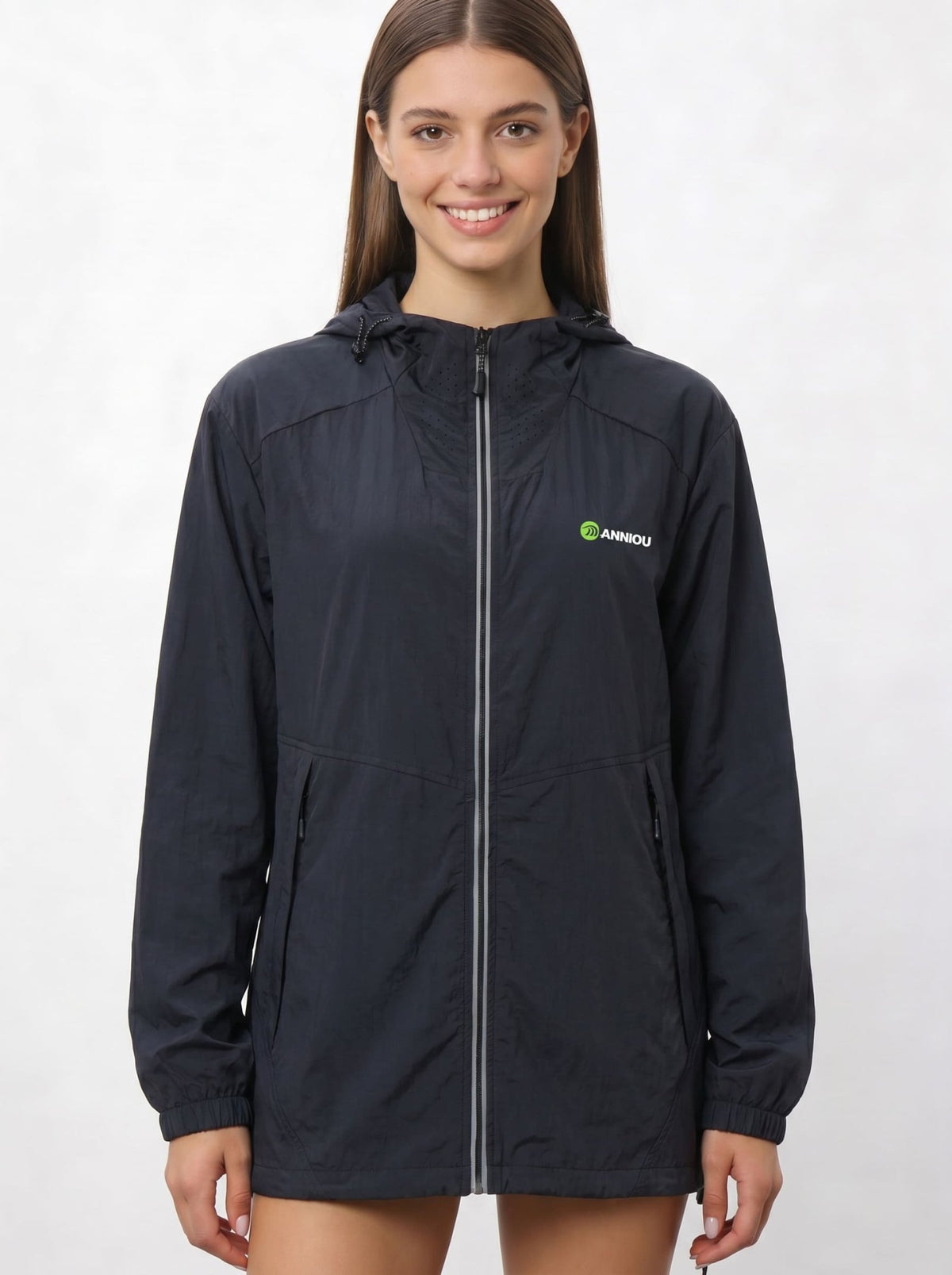 A woman wearing a black UV protection hooded jacket with a full front zipper and a green and white Anniou logo on the left chest, and breathable vents