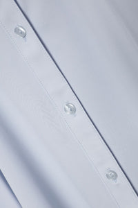 Close - up of a light gray fabric with button details