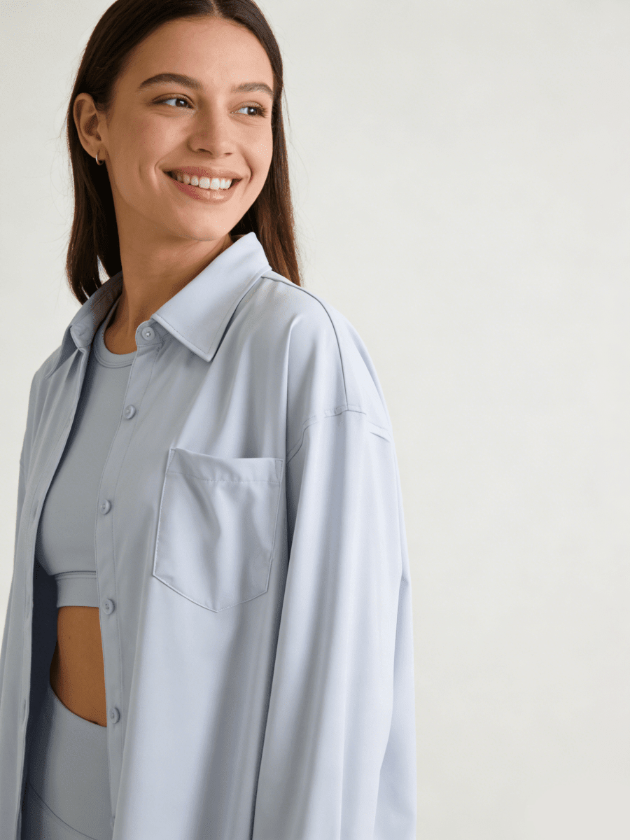 Woman wearing a light blue buttoned shirt with UPF 50+