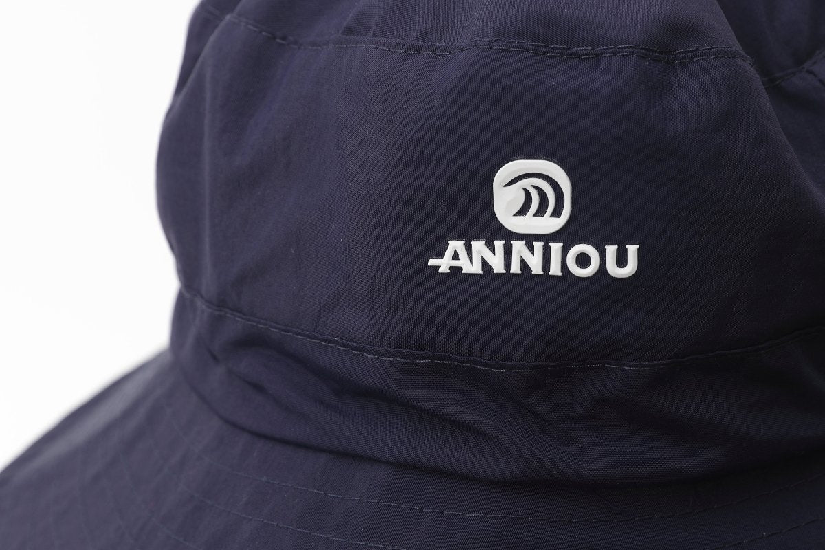 Navy blue cap with 'Anniou' logo on a white background