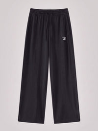 Black wide-leg sweatpants with an elastic waistband and a small white embroidered logo on the left thigh, shown against a light gray background.