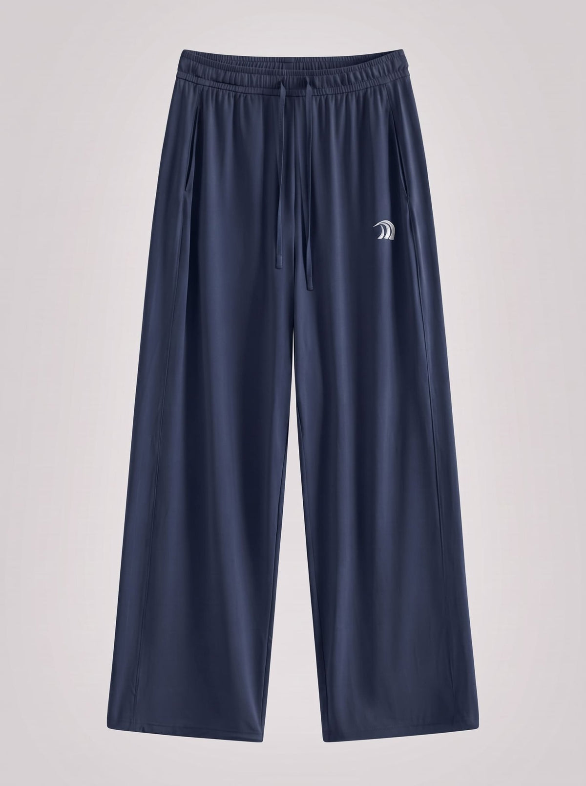 A pair of navy blue wide-leg athletic pants with an elastic waistband and drawstring, featuring a small white embroidered logo on the left thigh, shown against a light gray background.
