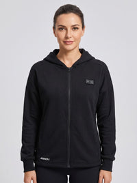 A woman wearing a black zip-up heated hoodie by Anniou