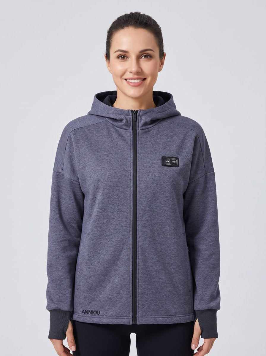 A woman wearing a grey blue zip-up heated hoodie with a black zipper.