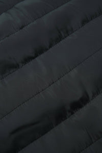 Close-up of a dark quilted puffer jacket fabric with diagonal stitching.
