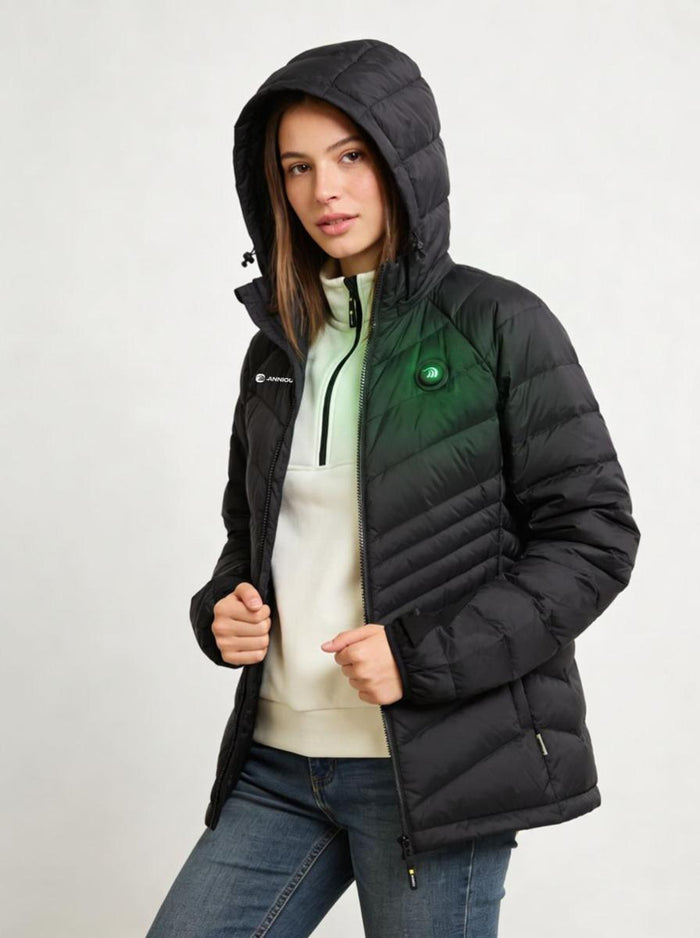 A young woman wearing a black hooded heated puffer jacket with a green and white logo on the right chest.