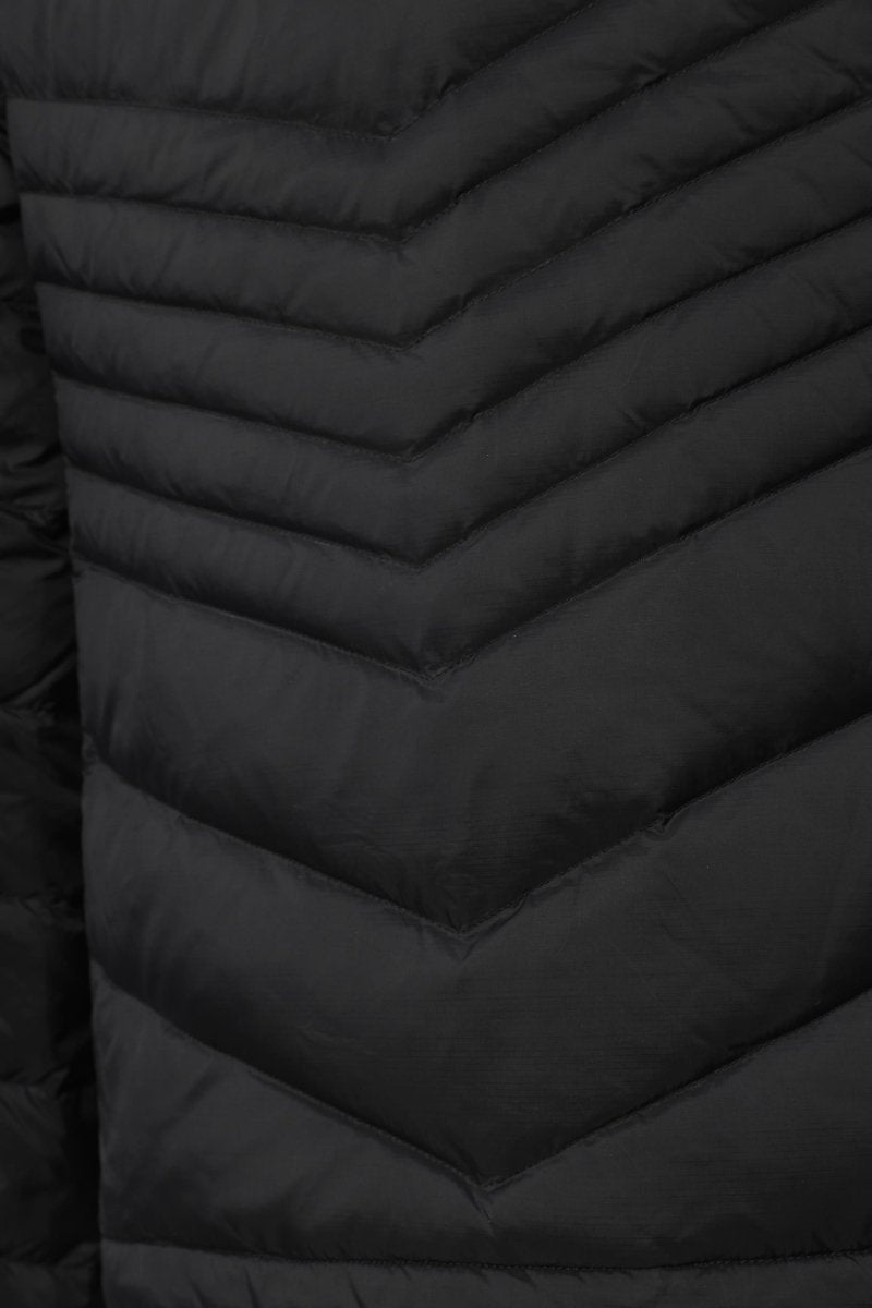 Close-up of a black puffer jacket showing the chevron quilted pattern and padded texture.