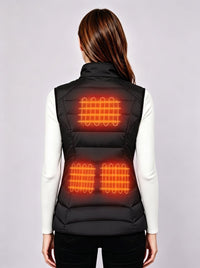 Back view of women's black heated vest, visual glowing heating elements on upper back and lower back