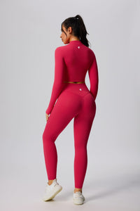 Person wearing a red athletic outfit with sports jacket and uplift leggings
